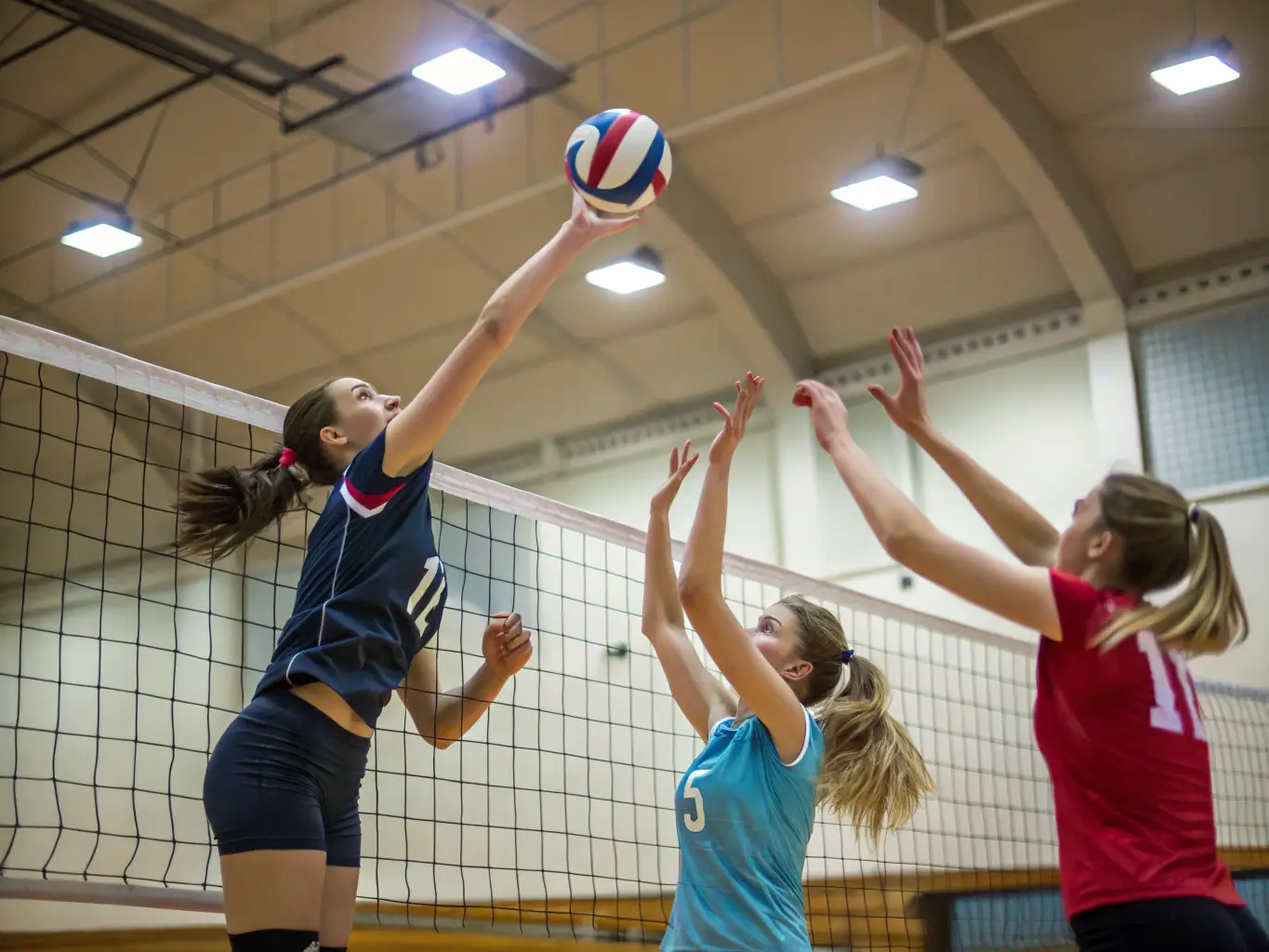A vibrant image of students engaged in a friendly volleyball match during an inter-faculty tournament, capturing the spirit of competition and camaraderie.