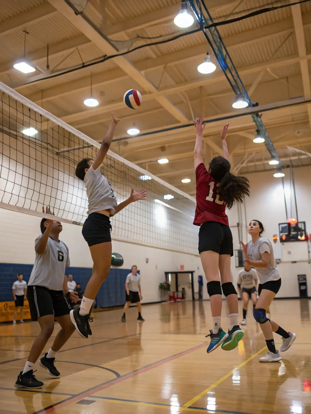 A vibrant image of students participating in a volleyball match, part of the inter-faculty sports events, with enthusiastic spectators cheering them on.